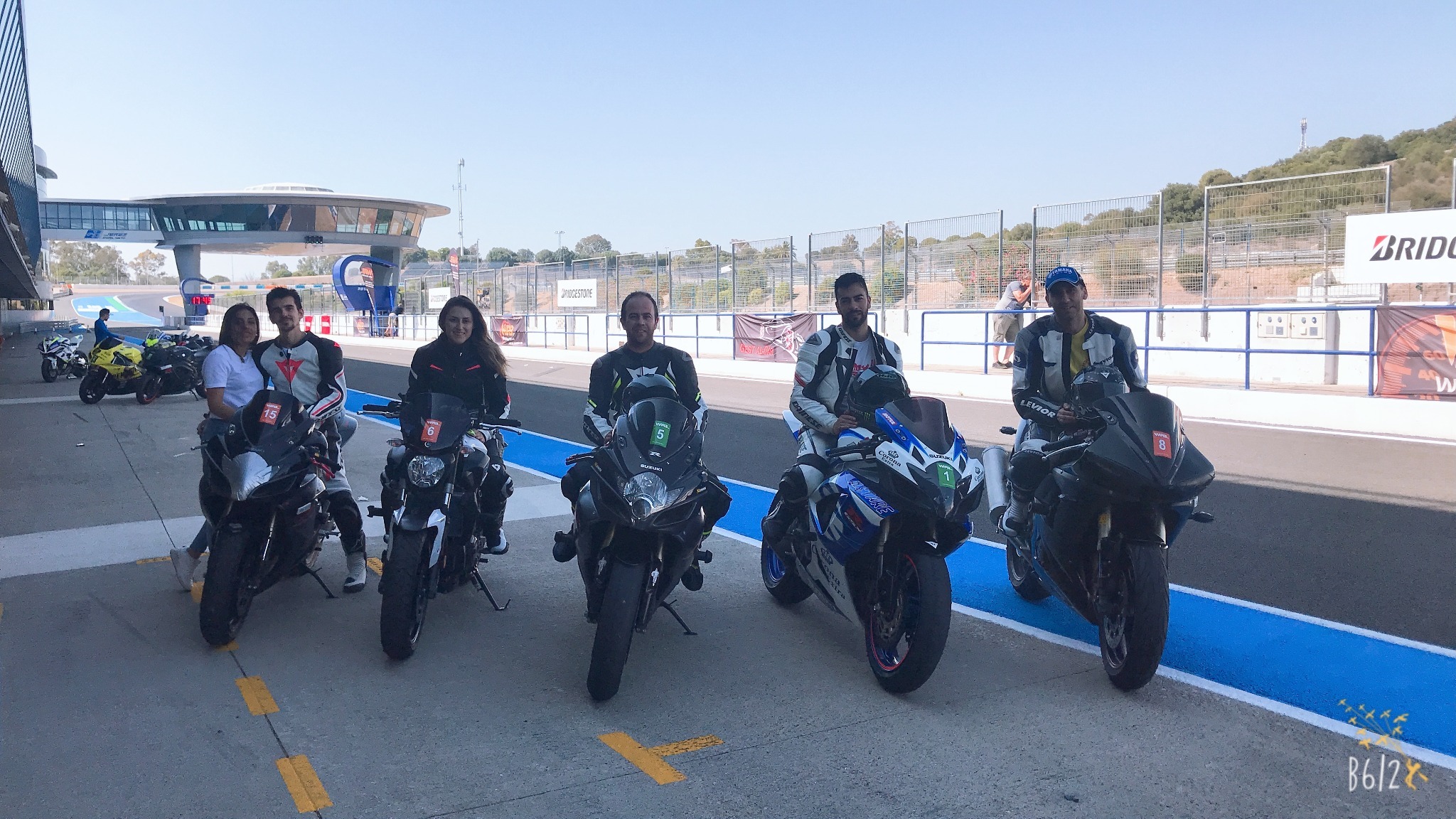 Grupo de participantes con sus motocicletas en el pit lane del Circuito de Jerez en 2021